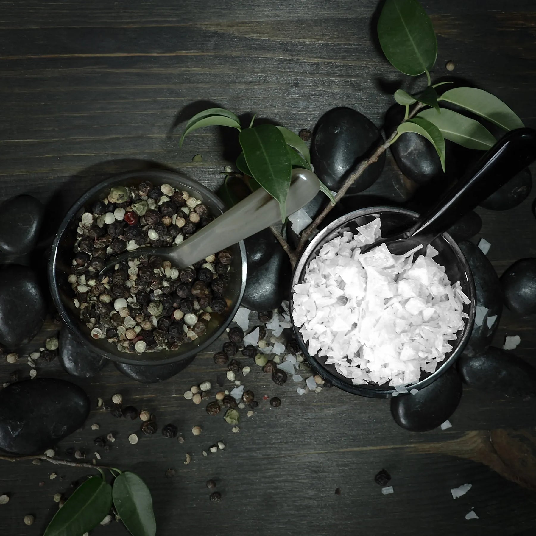 Salt and pepper bowls with spoon.