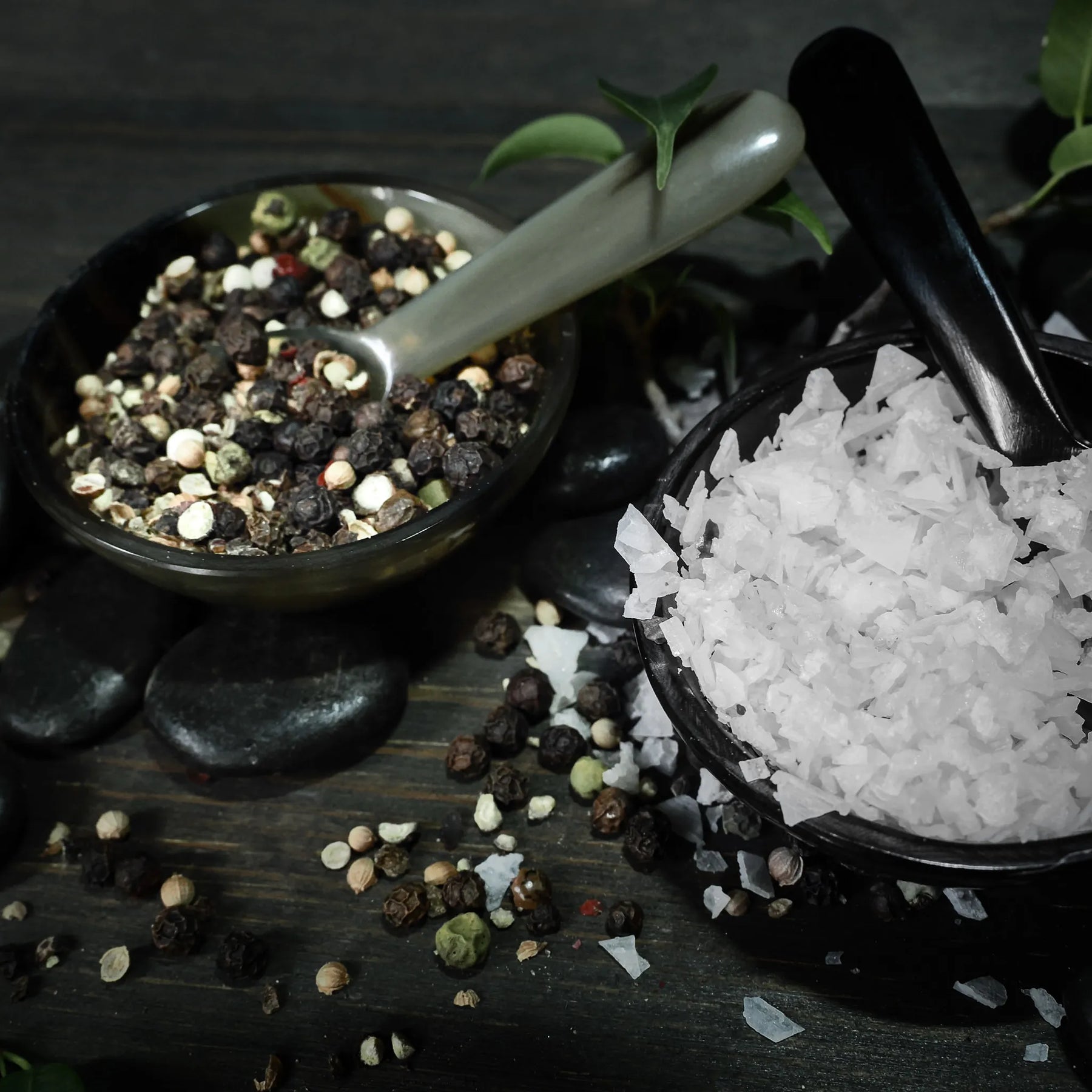 Salt and pepper bowls with spoon.