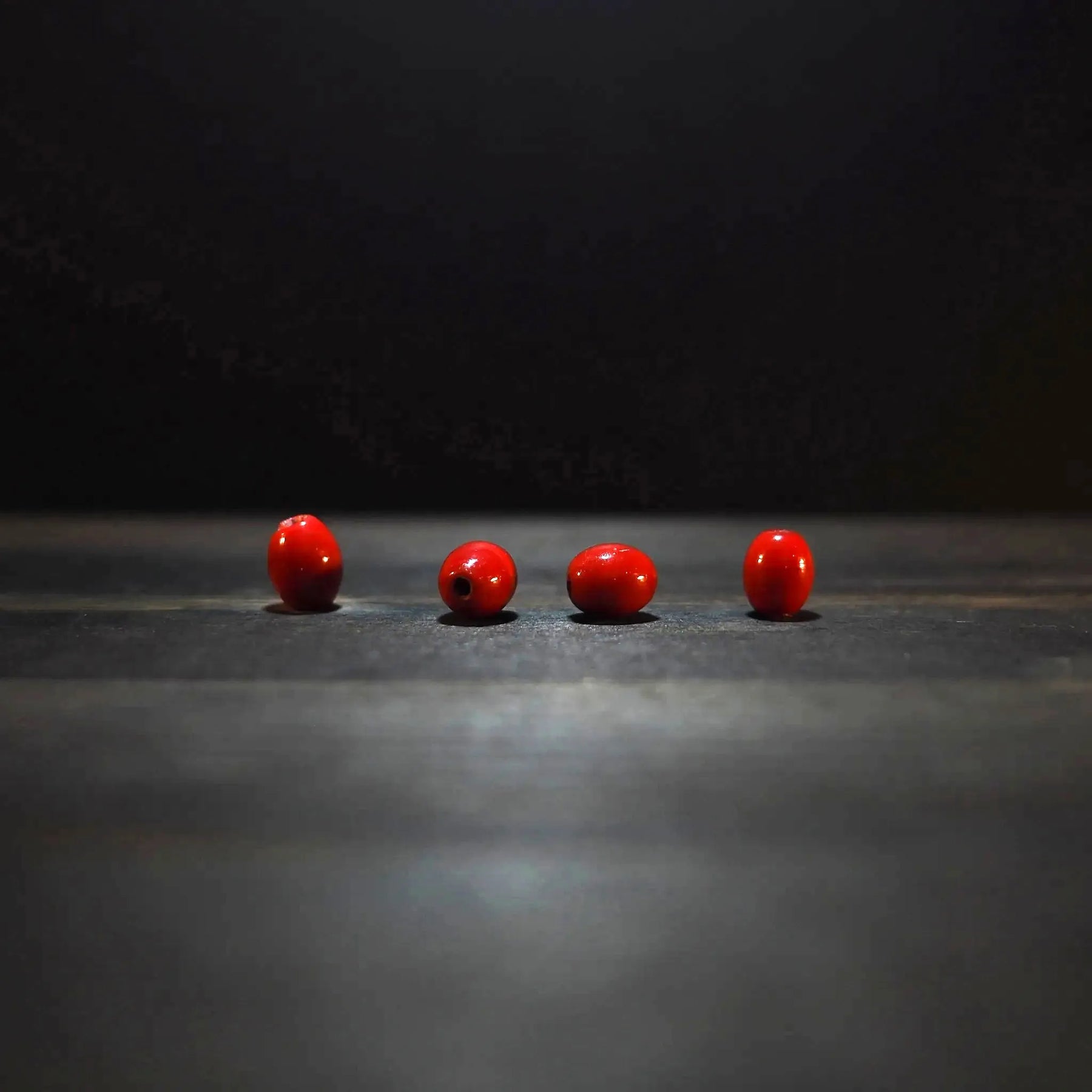 Oval red glass bead