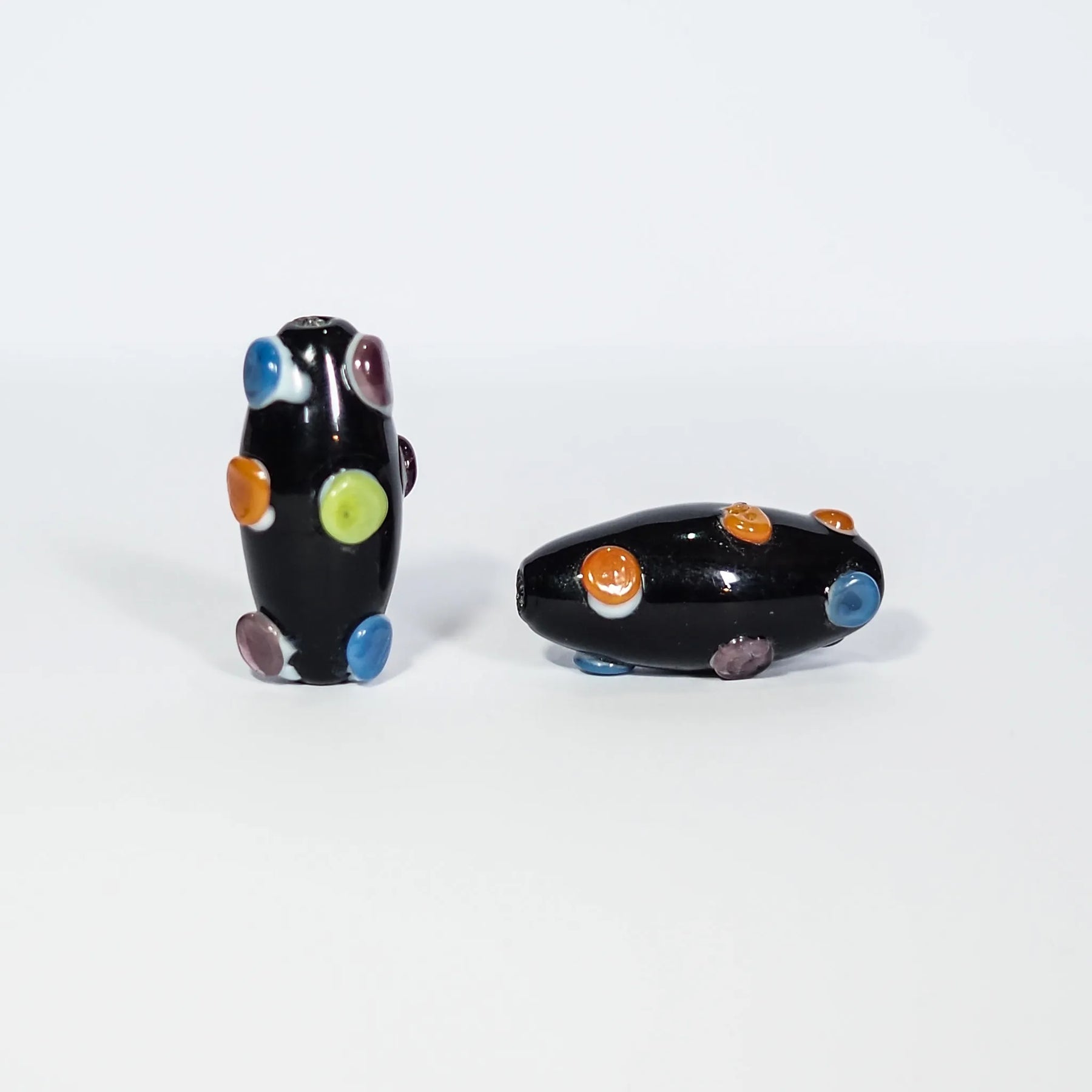 Dark bead with dots in bright colors