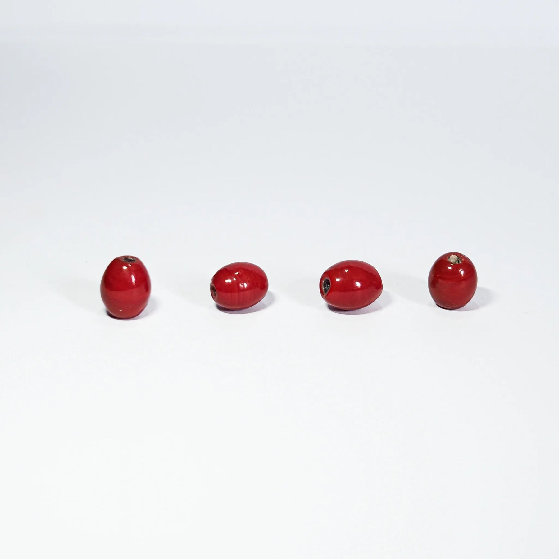 Oval red glass bead