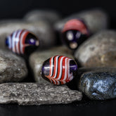 Blue bead with white-red stripes
