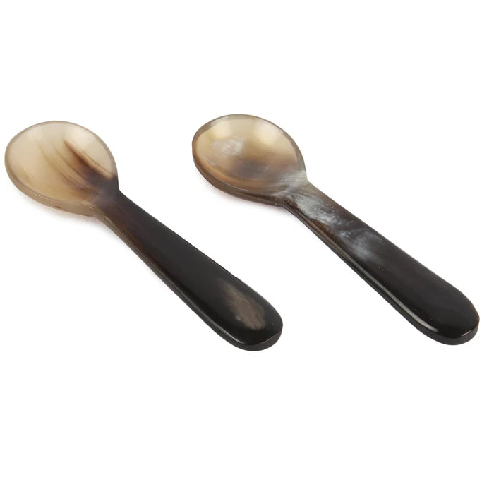 Salt and pepper bowls with spoon.