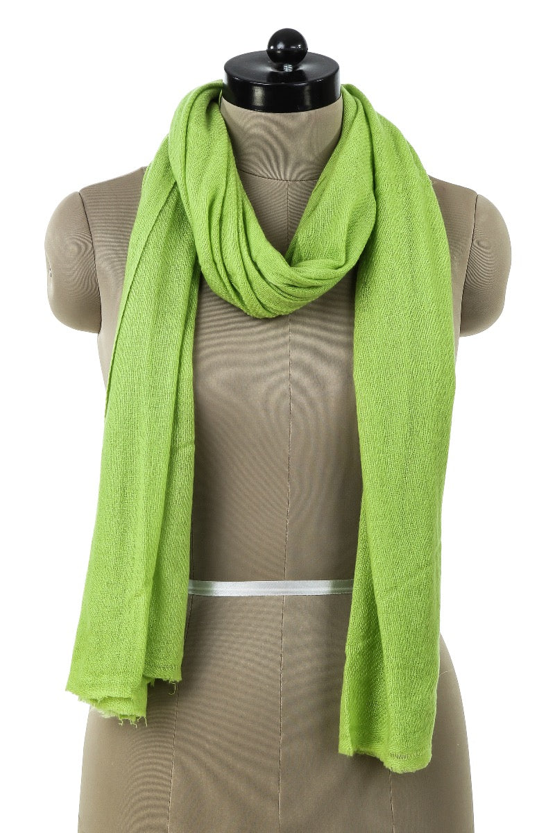 Light green cashmere shawl in soft wool material, draped on a dressmaker's dummy to show elasticity and finely knitted texture