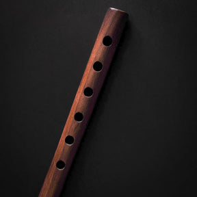 Wooden flute toy with decorative bottom ring, full vertical view
