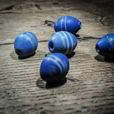 Blue elongated glass bead with white stripes – replica of a find in Uppsala