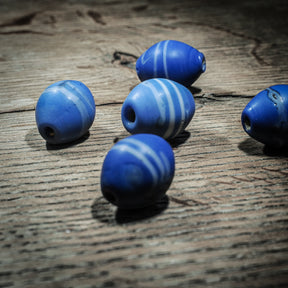 Blue elongated glass bead with white stripes – replica of a find in Uppsala