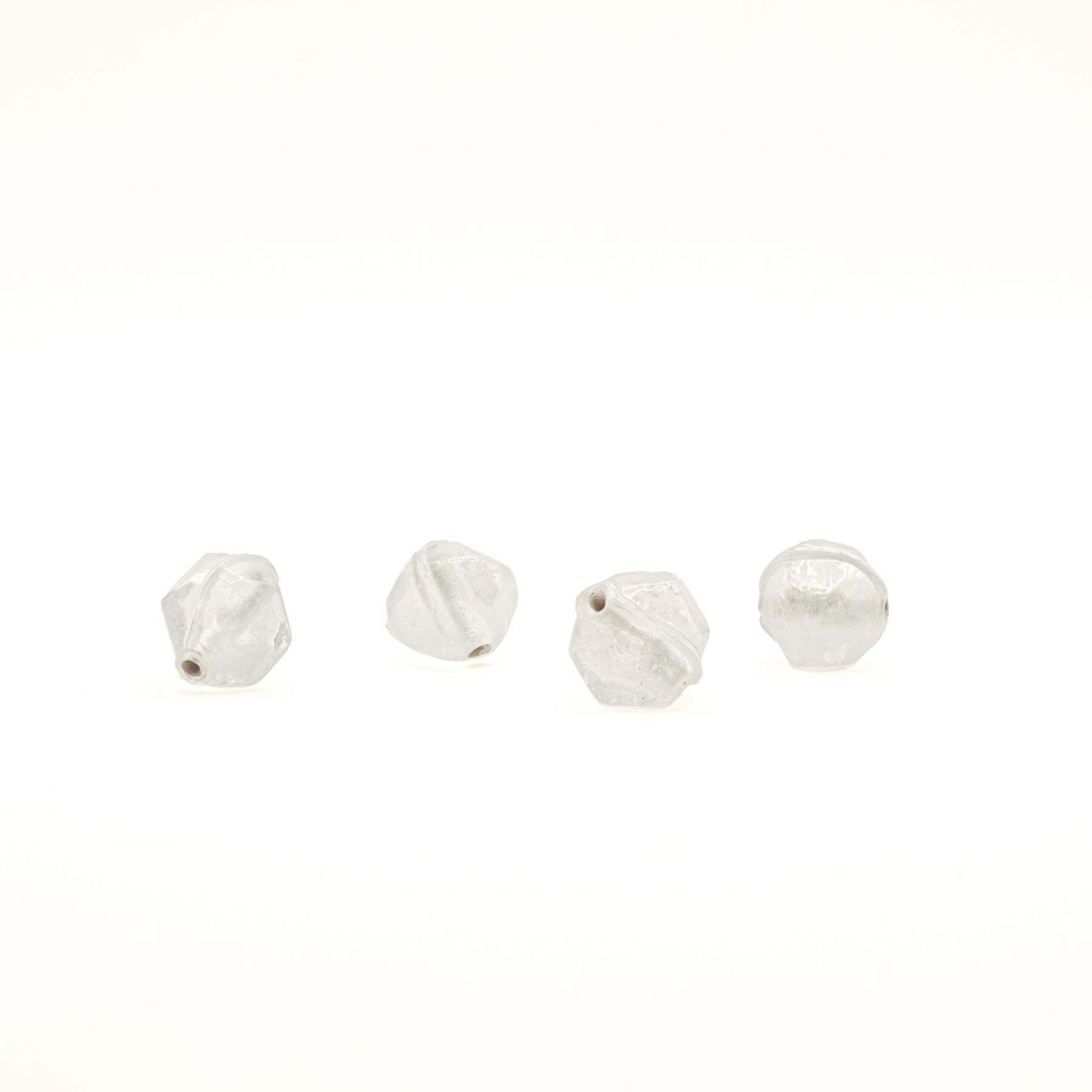 Angular glass bead Birka – four transparent beads in a row, hole visible on two of them