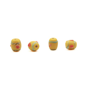 Yellow glass bead Birka – four beads in a row, two standing and two lying, with red dots