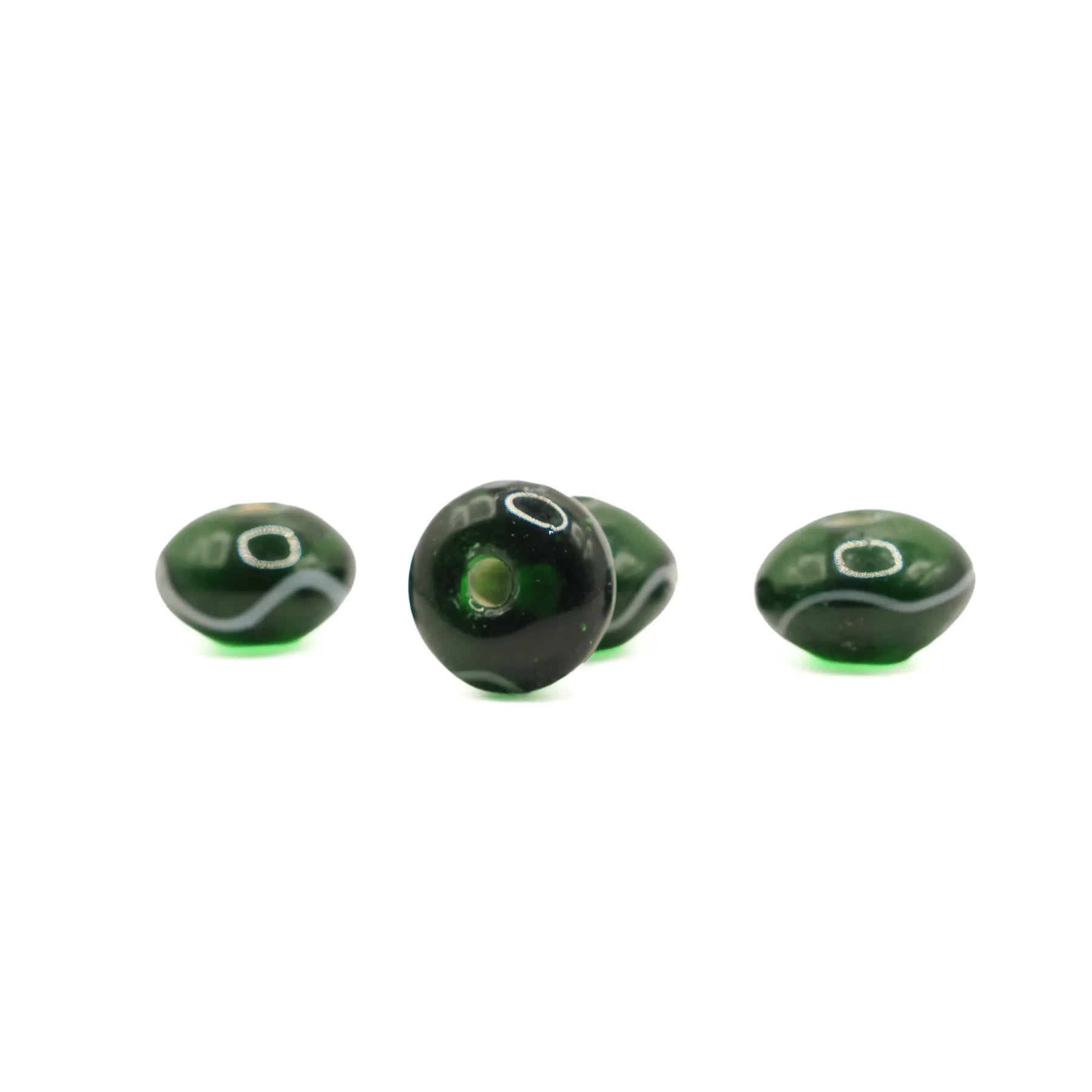 Green glass bead Birka – four beads in a row, one facing hole-forward and three from the side