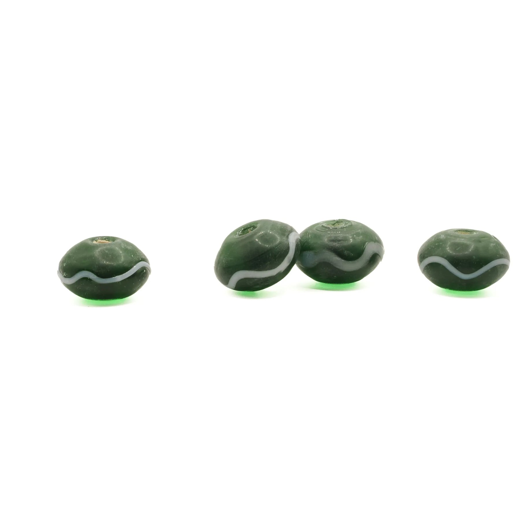 Green glass bead Birka – four beads in a row from the side, flat round shape with white wave decoration around the edge