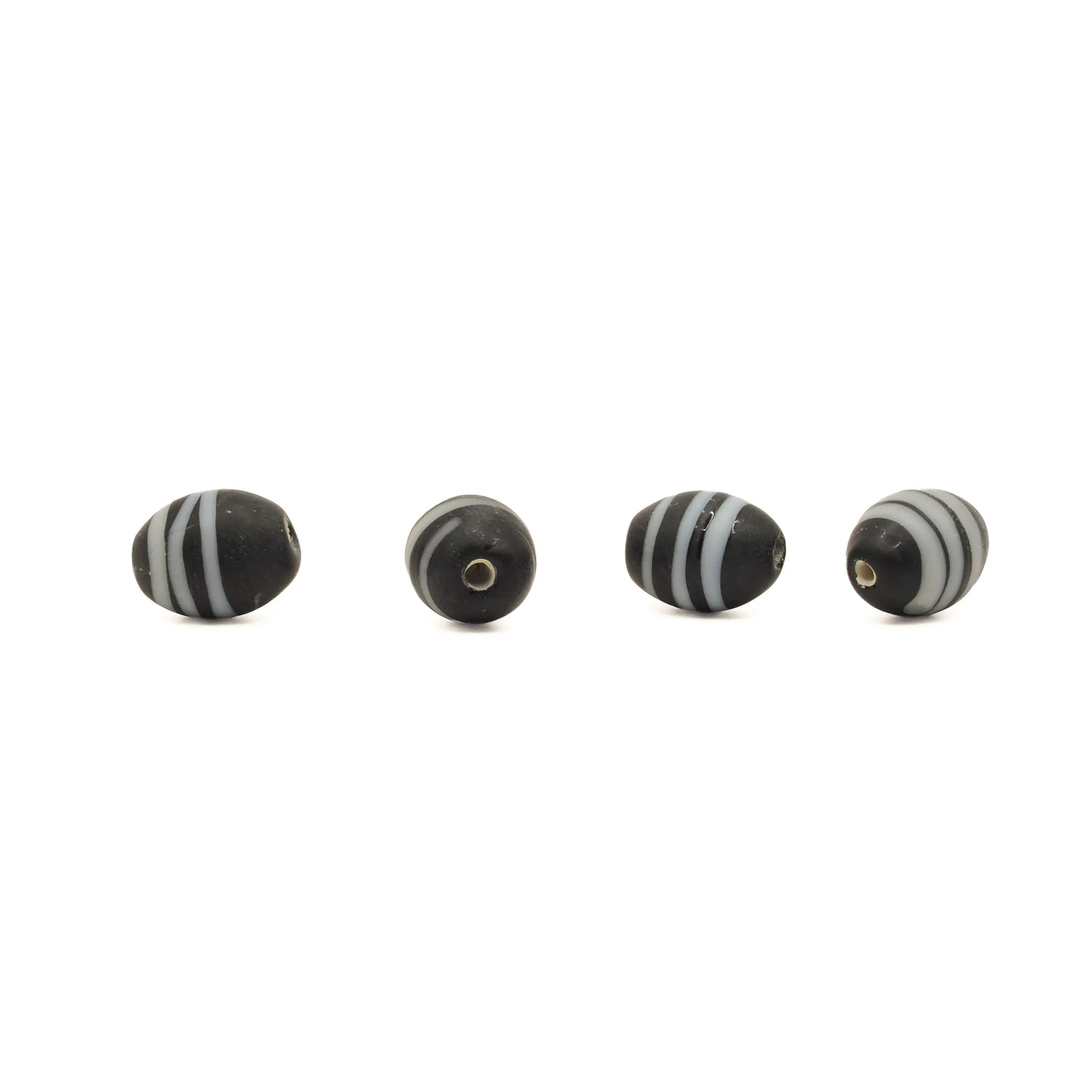 Black glass bead Gotland – four beads in a row, one seen straight from the hole end and three from the side