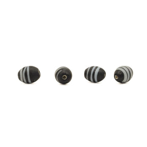 Black glass bead Gotland – four beads in a row, one seen straight from the hole end and three from the side