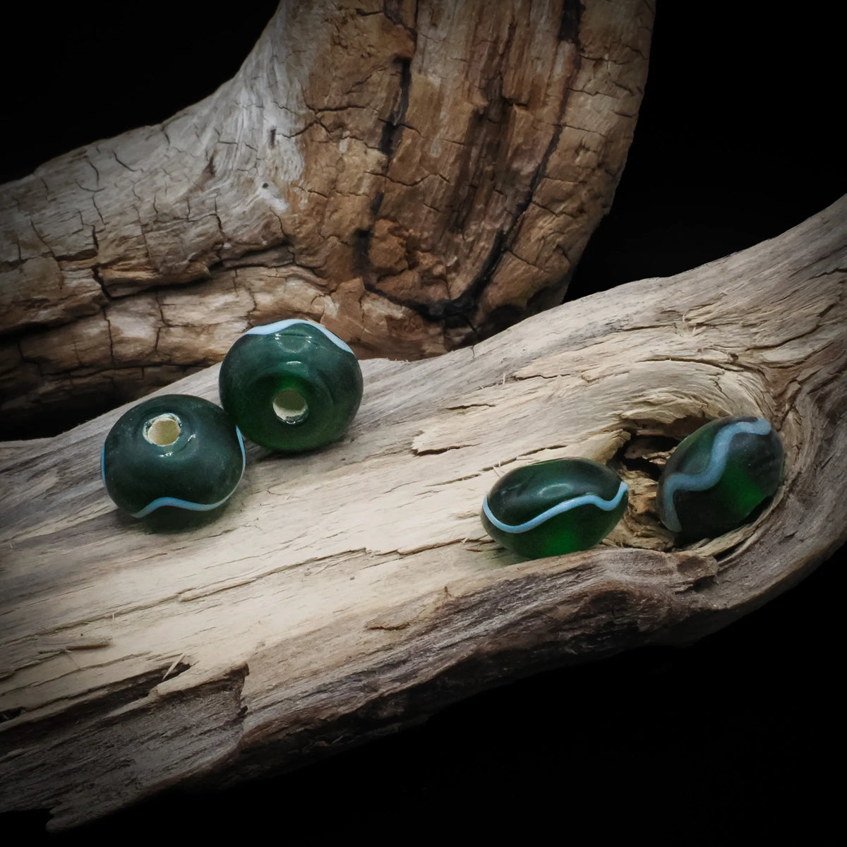 Green glass bead Birka – four beads with wavy white decoration, hole visible on two