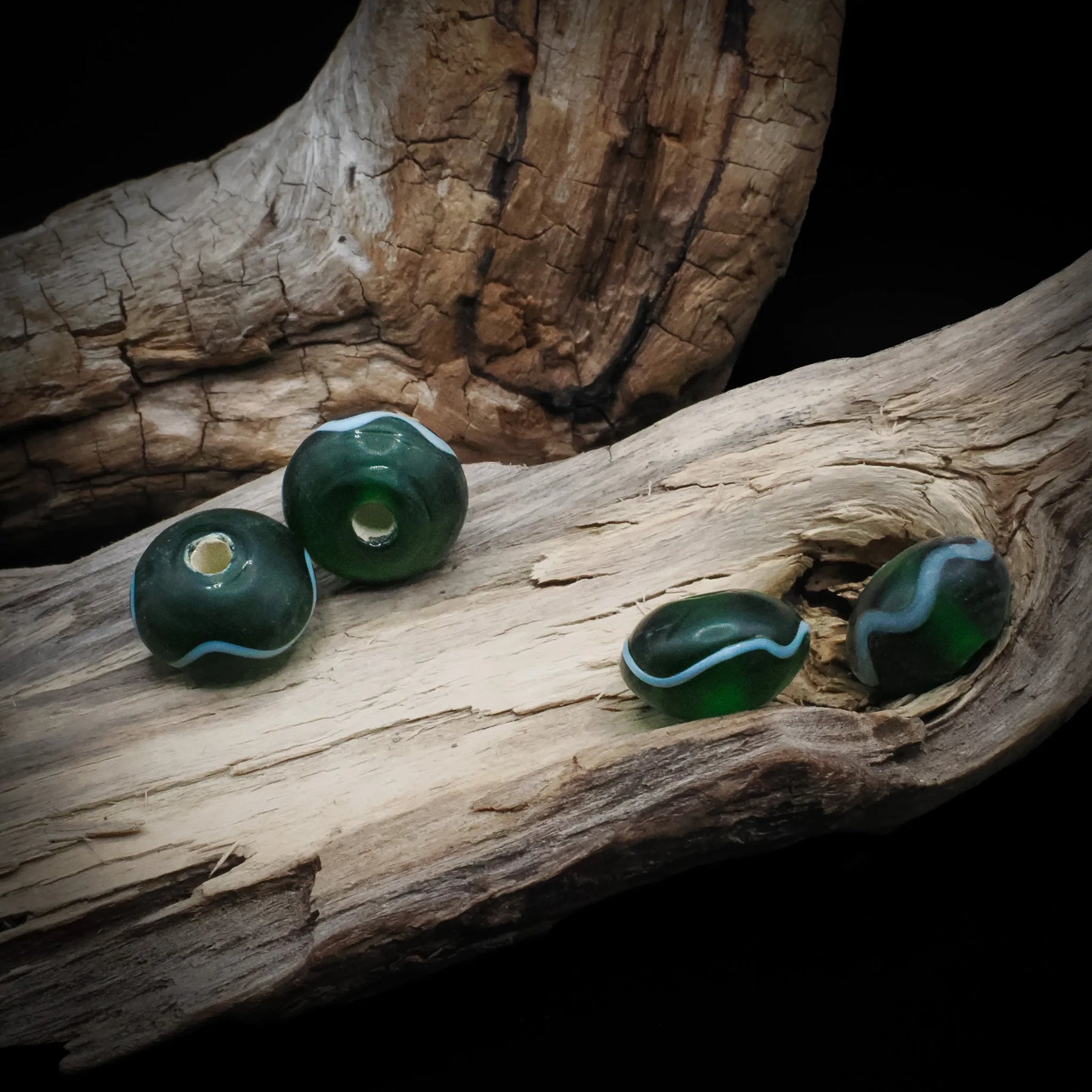 Green glass bead Birka – four beads with wavy white decoration, hole visible on two