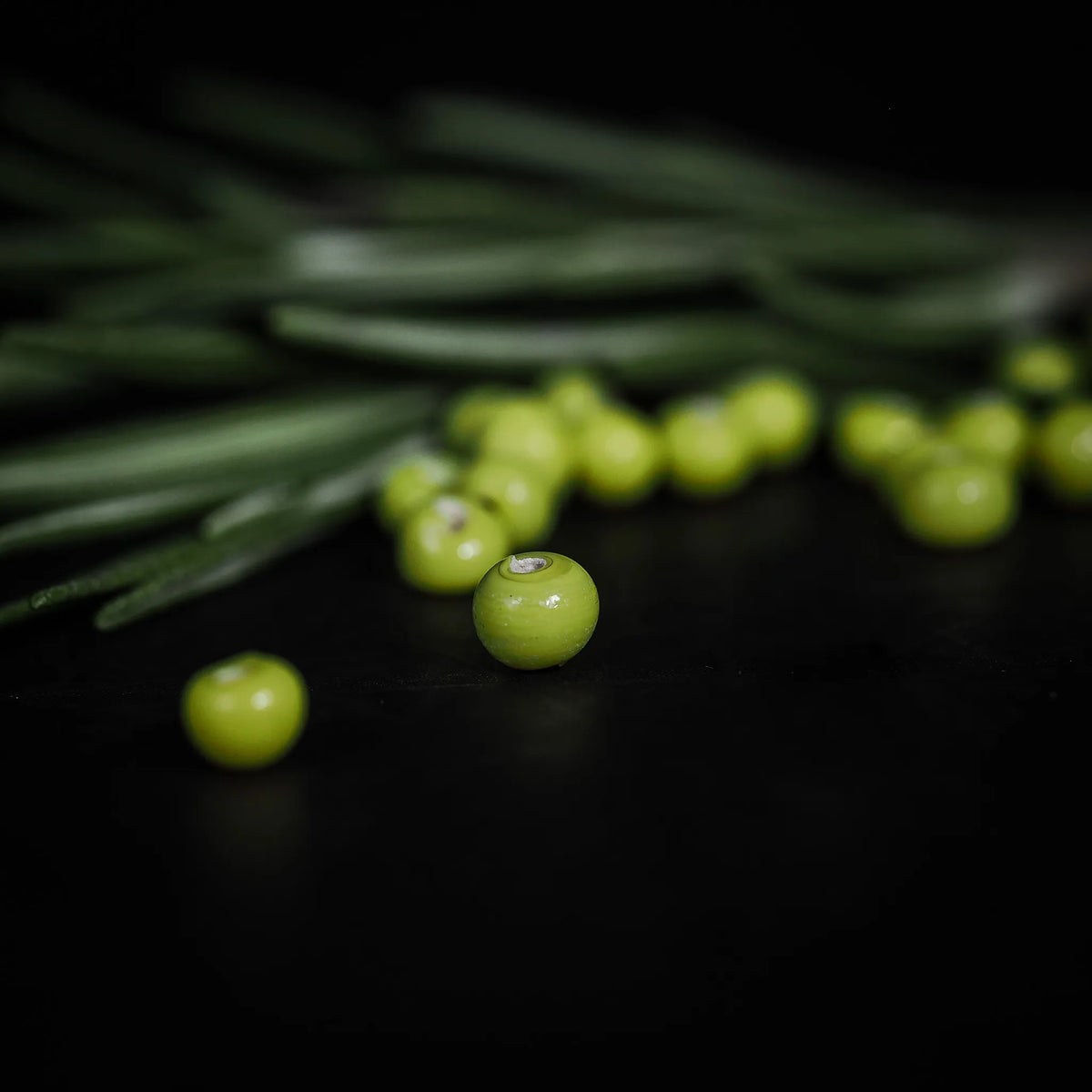 Handmade, small lime green glass bead 07700044