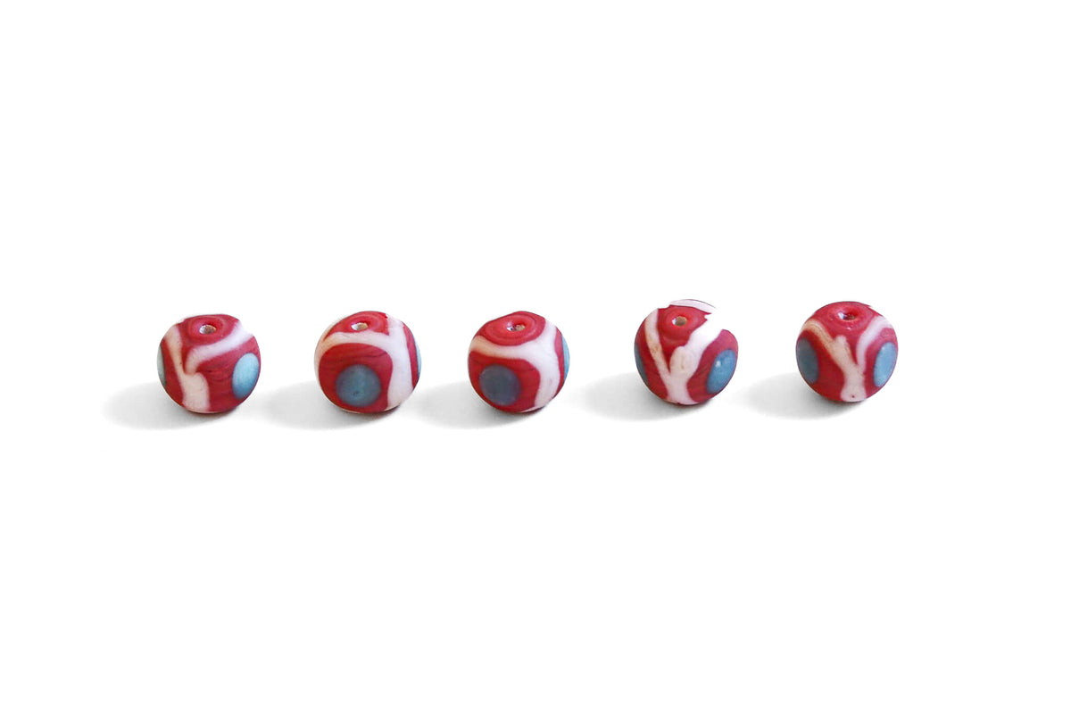 Red glass bead with decoration, matt