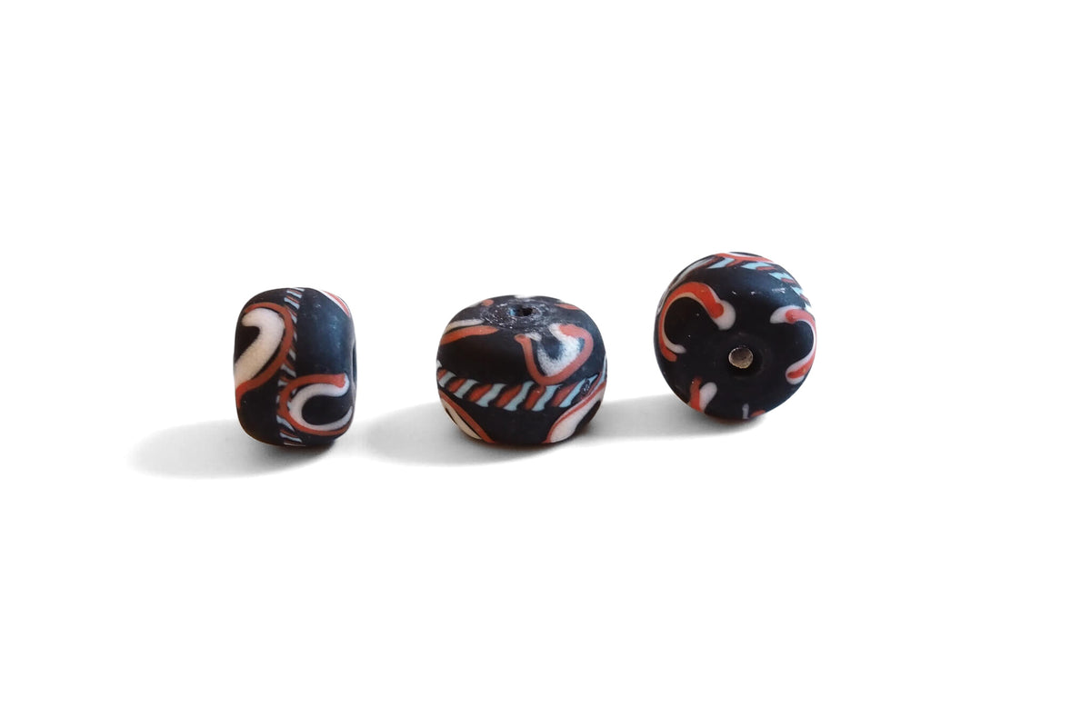 Large black glass bead with decoration, matt