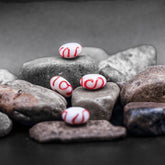 White glass bead with orange decoration