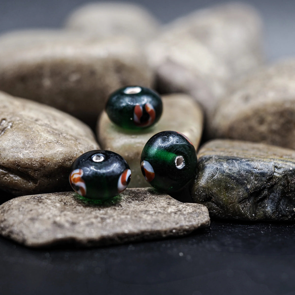 Green glass bead with red-white eye