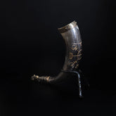 Drinking horn with raven and engraving with horn stand.