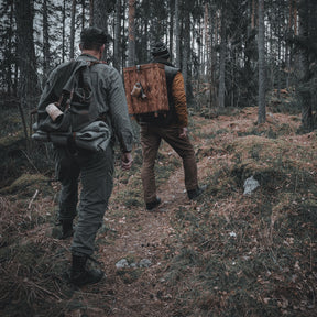 Felted wool blanket, sleeping mat – rolled up and strapped to a backpack in forest terrain