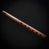 Wooden flute toy with multiple finger holes, traditional folk instrument design
