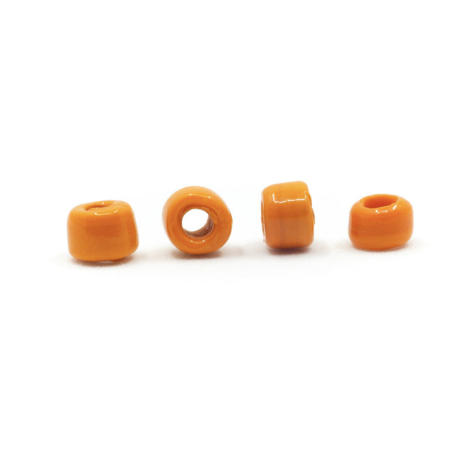 Orange glass bead, Gotland – four barrel-shaped beads in a row