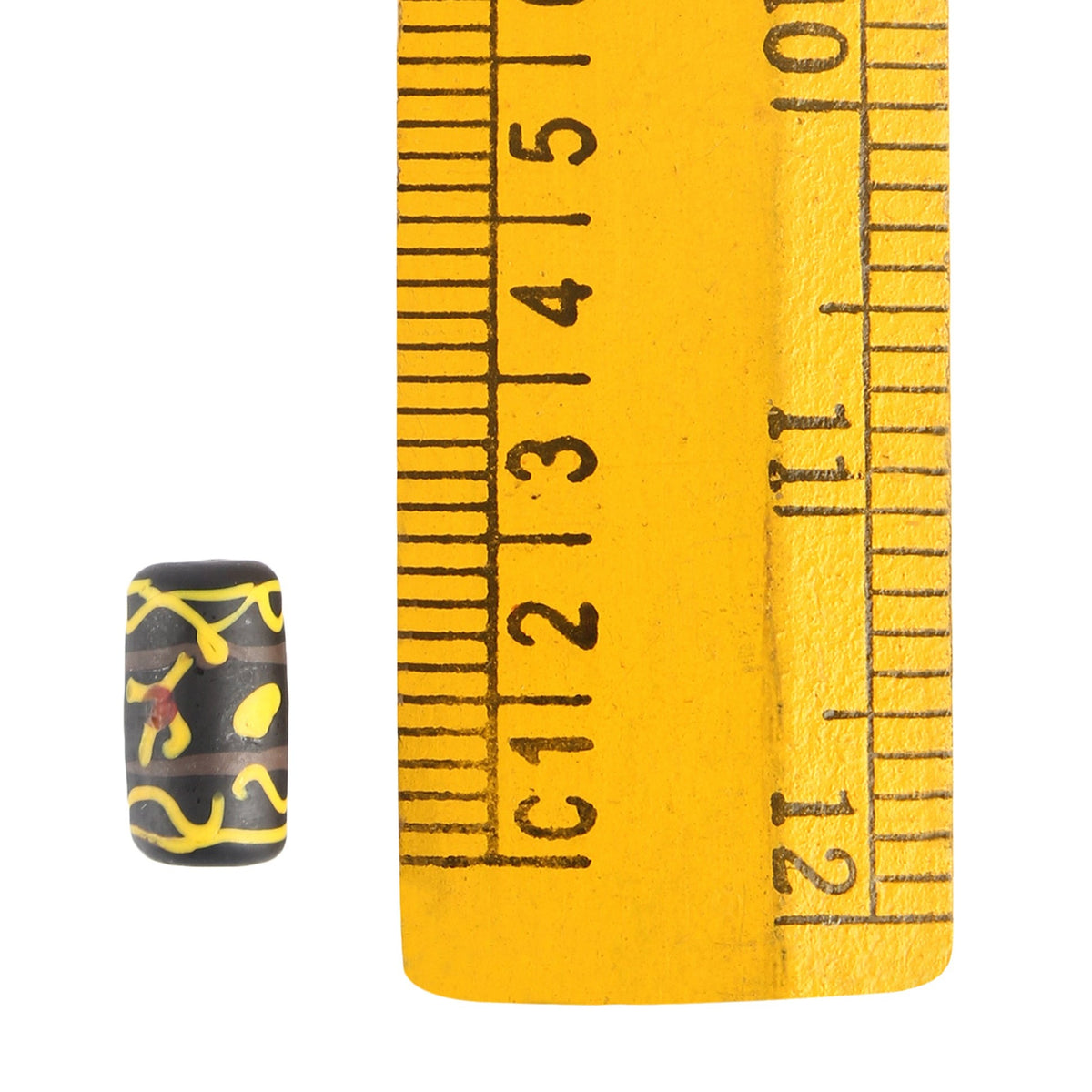 Black glass bead with yellow decoration, Storfossen – next to a ruler, the bead measures approx. 1 cm